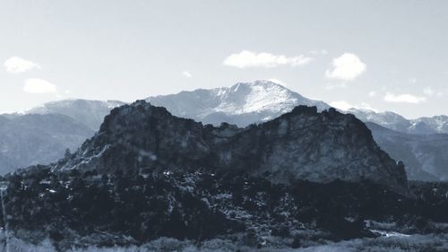 Scenic view of mountains against cloudy sky