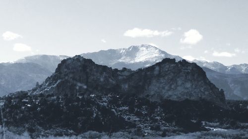 Scenic view of snow covered mountains against sky
