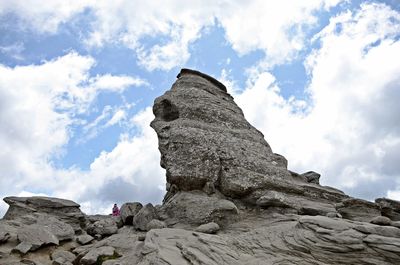 Low angle view of rock formation against sky