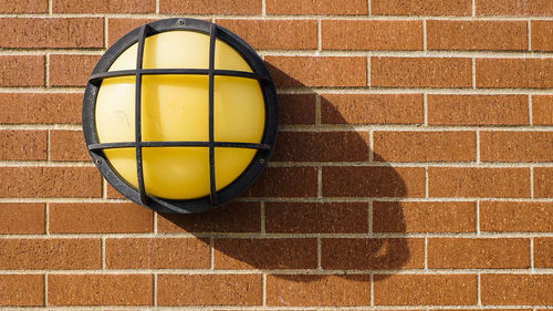 Close-up of recessed light on brick wall