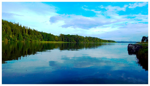 Scenic view of lake against cloudy sky