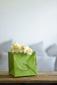 Close-up of yellow rose on table