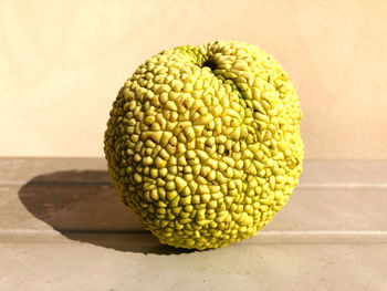 Close-up of fruit on table against wall