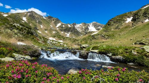 Scenic view of lake by mountain against sky