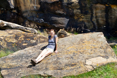 High angle view of hiker sitting on rock