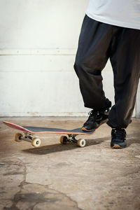 Low section of man skateboarding on skateboard