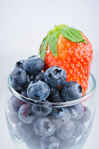 Close-up of strawberries in bowl against white background