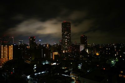 Illuminated skyscrapers in city at night
