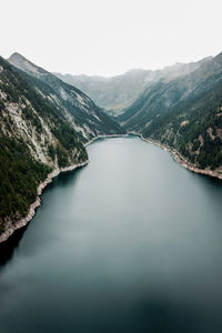 Scenic view of river amidst mountains against clear sky