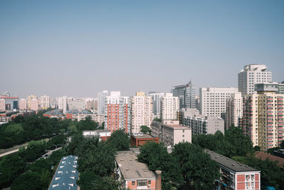 High angle view of buildings in city against clear sky