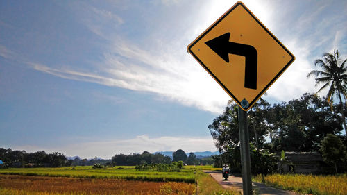 Road sign against sky