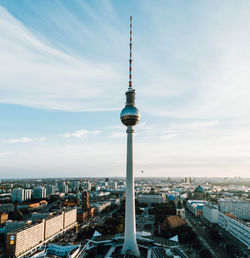 Tower amidst buildings in city against sky