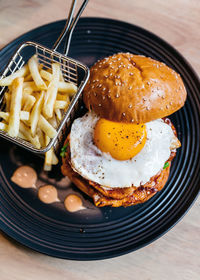 High angle view of egg burger served on table