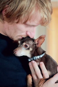 Close-up of hand holding dog