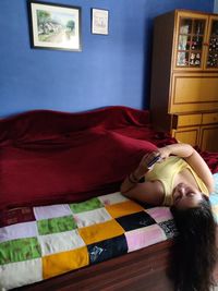 Woman sleeping on bed at home