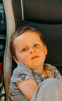 Portrait of cute baby boy on chair