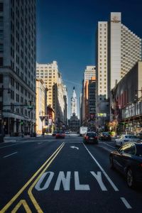 View of city street and buildings against sky