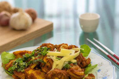 Golden brown crunchy turmeric fried chicken, on a white plate, is a favorite in malaysia