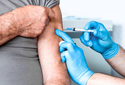 Doctor vaccinating senior man. elderly people vaccination. covid19 coronavirus vaccine injection 