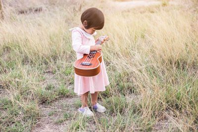 Full length of girl playing on field