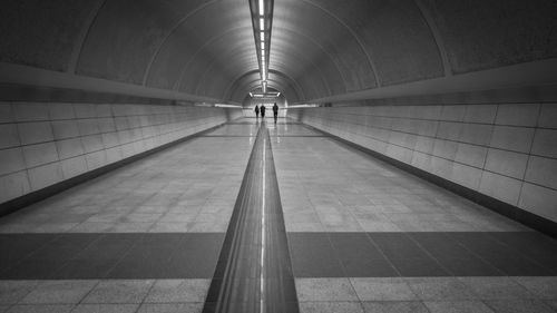 Distance shot of people walking in subway