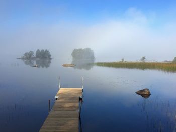 Pier on lake against sky