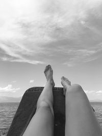 Low section of woman relaxing at beach