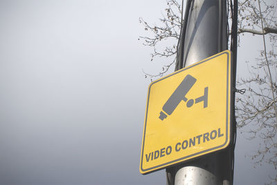 Low angle view of road sign against sky