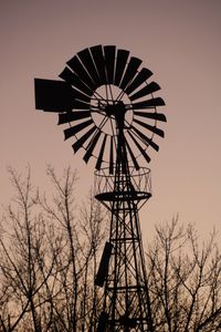 Low angle view of traditional windmill against sky