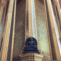 Low angle view of statue against temple