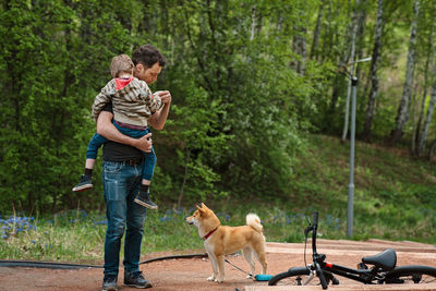 Full length of people with dog at park