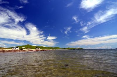 View of beach against cloudy sky