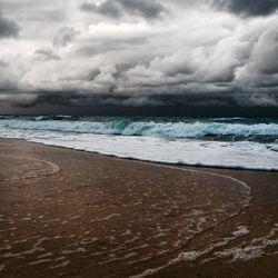 Scenic view of sea against cloudy sky