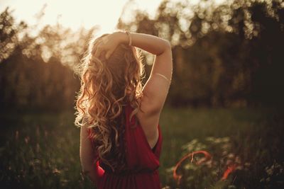 Midsection of girl standing by tree