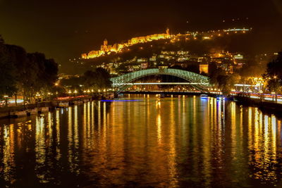 Pedestrian bridge of peace over the kura river, narikala fortress and kartlis deda monument 