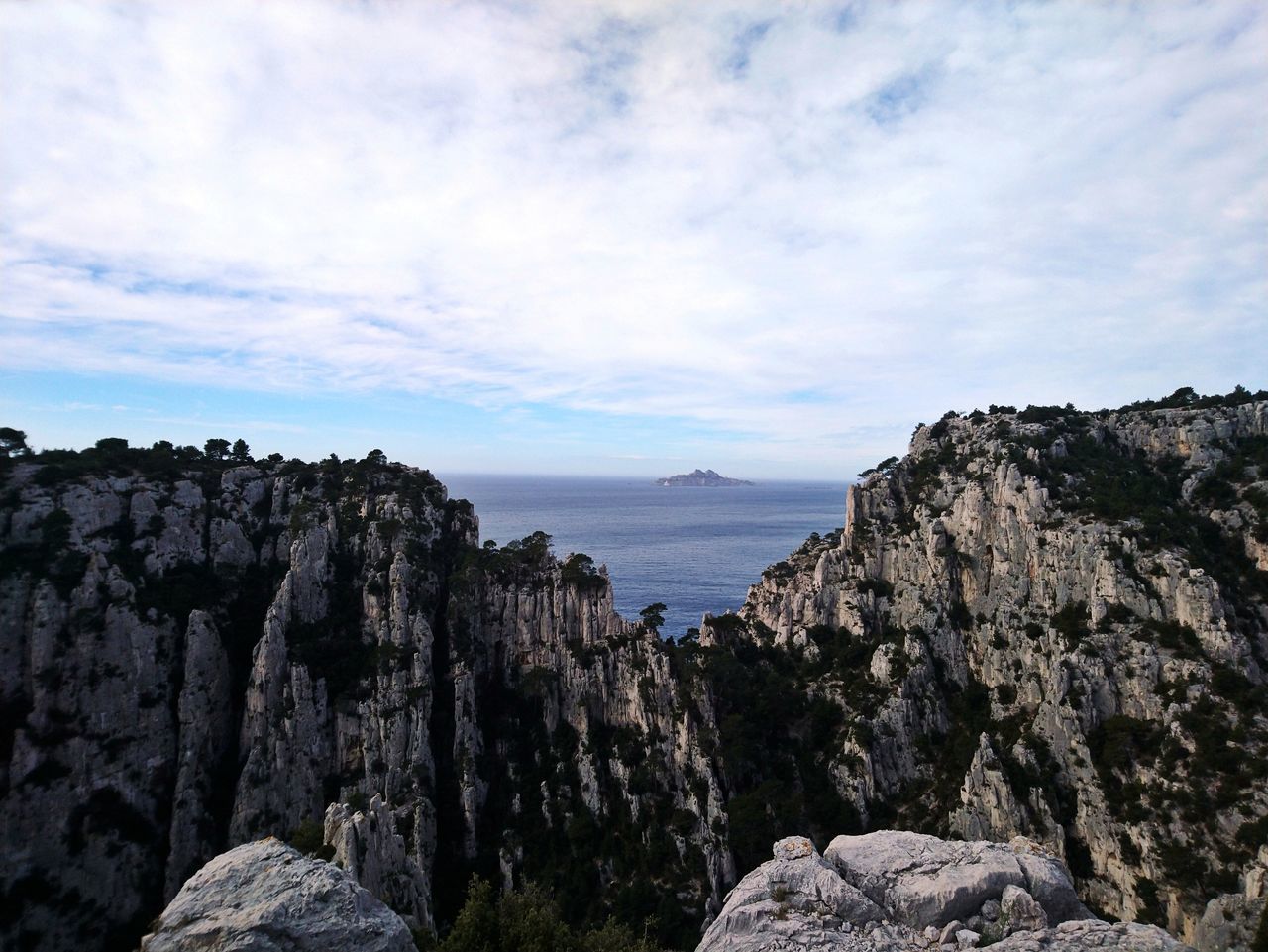 sky, rock, cloud - sky, water, rock - object, nature, sea, environment, cliff, beauty in nature, rock formation, landscape, land, mountain, solid, scenics - nature, outdoors, no people, strength, formation, high