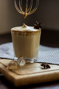 A glass of the popular trendy drink dalgona coffee with milk. whisk and ice. high quality photo