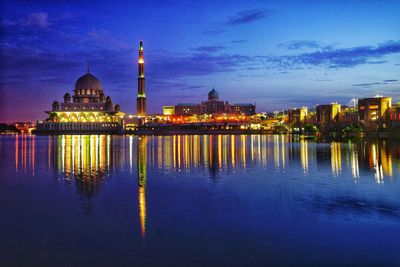 Illuminated buildings in city at dusk
