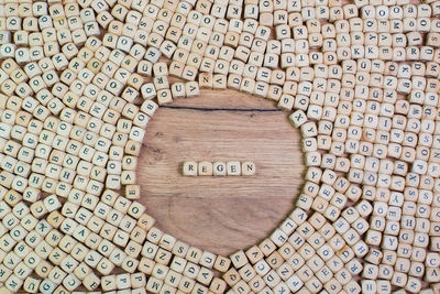 High angle view of alphabets on blocks at wooden table