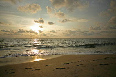 Scenic view of beach against sky during sunset