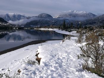 Scenic view of frozen lake against snowcapped mountains