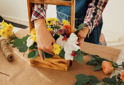 Midsection of woman holding flower bouquet