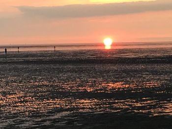 Scenic view of sea against orange sky