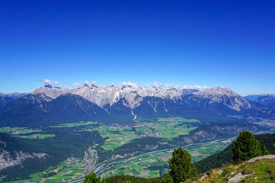 Scenic view of mountains against clear blue sky