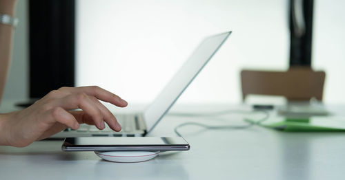 Man using mobile phone on table