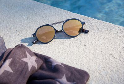 Close-up of sunglasses on swimming pool