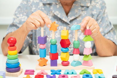 Midsection of man playing with toy blocks