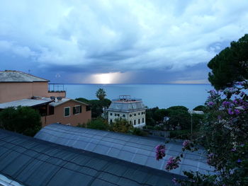 High angle view of buildings and sea against sky