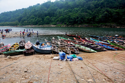 High angle view of people by boats moored in river