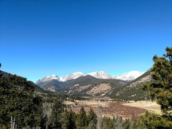 Scenic view of mountains against clear blue sky